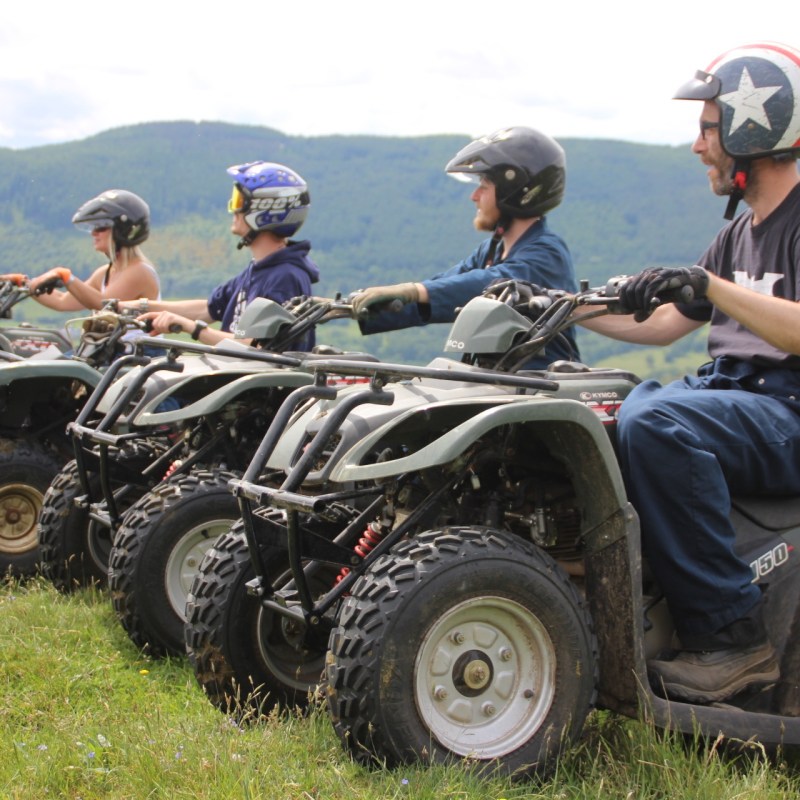 a group of people sitting around a car