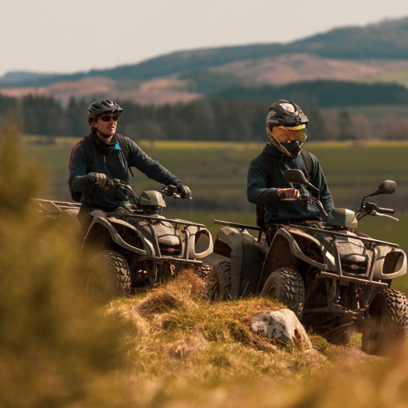 a man riding a motorcycle in a field