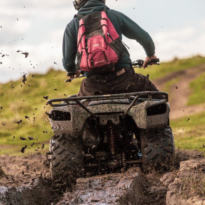 a man riding a bike down a dirt road