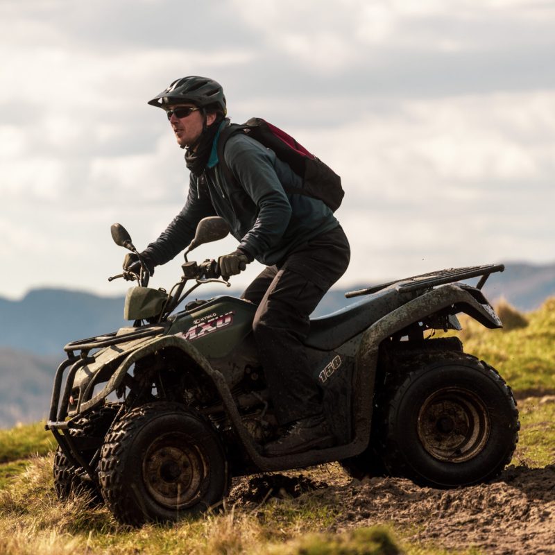 a man flying through the air while riding a bike down a dirt road