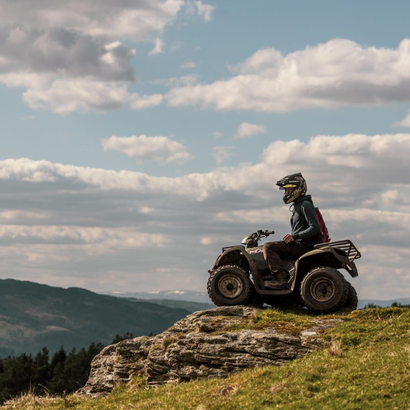 a motorcycle is parked on the side of a hill