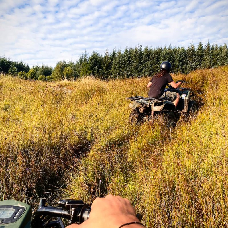 a man riding a motorcycle down a dirt road