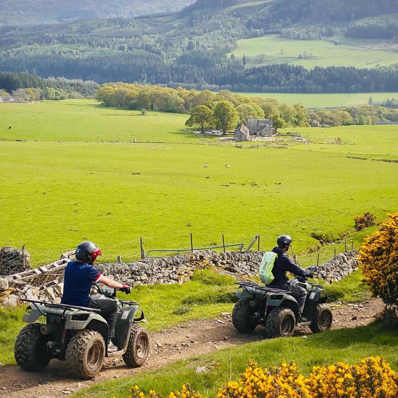 a group of people sitting on a grassy hill
