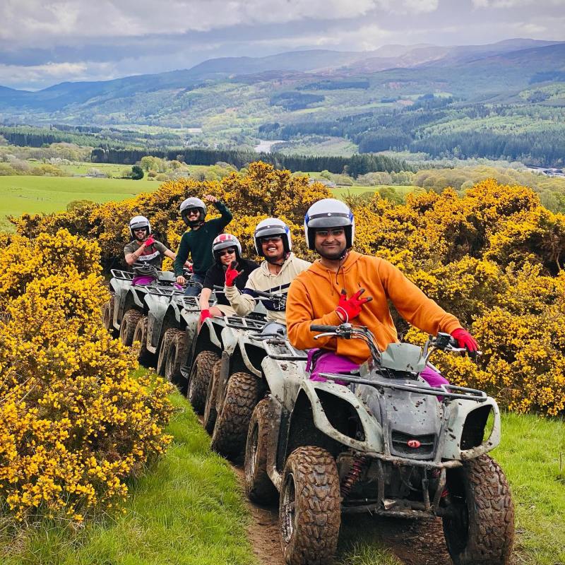 a group of people riding on the back of a motorcycle