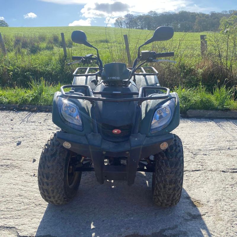 a motorcycle is parked on the side of a vehicle