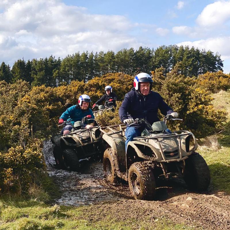 a group of people riding on the back of a motorcycle