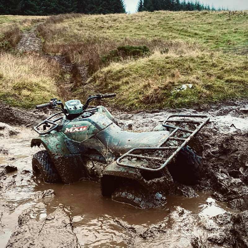 a car parked on the side of a dirt field