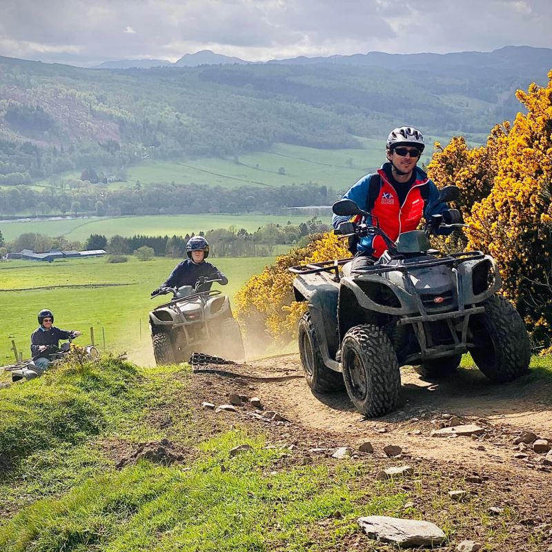 a man riding a motorcycle down a dirt road