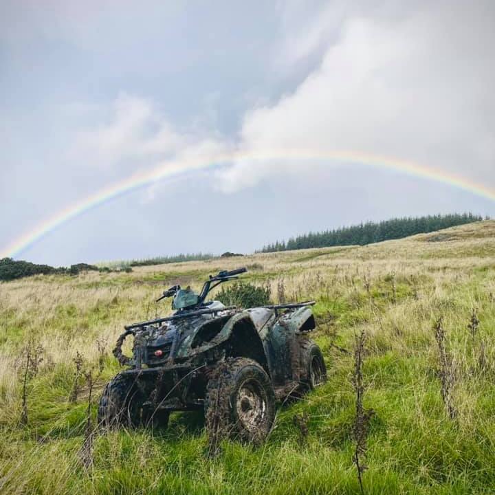 a truck that is sitting on the side of a dirt field
