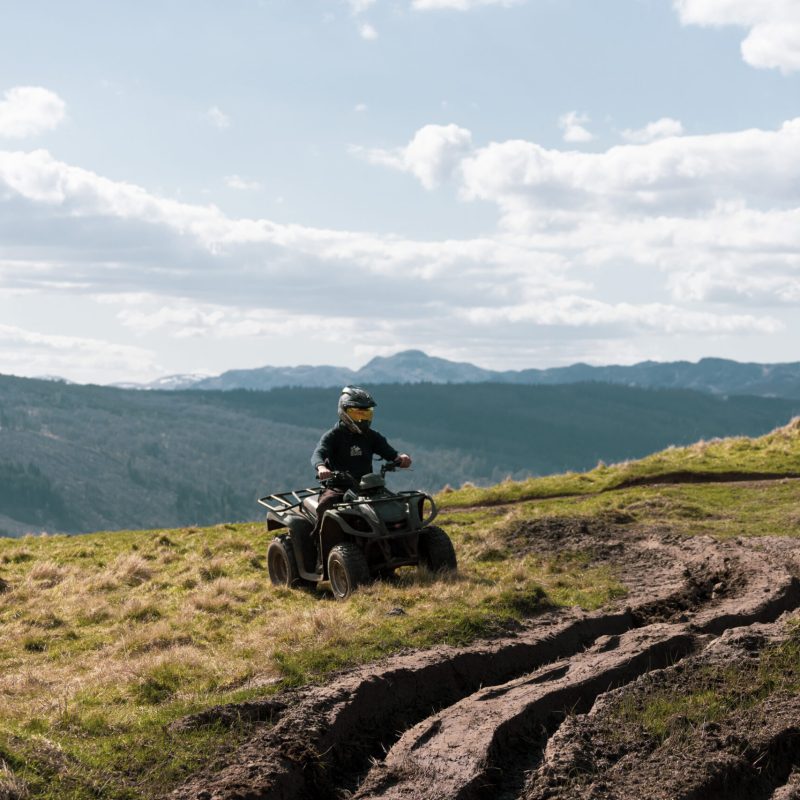 a man riding a motorcycle on a grassy hill