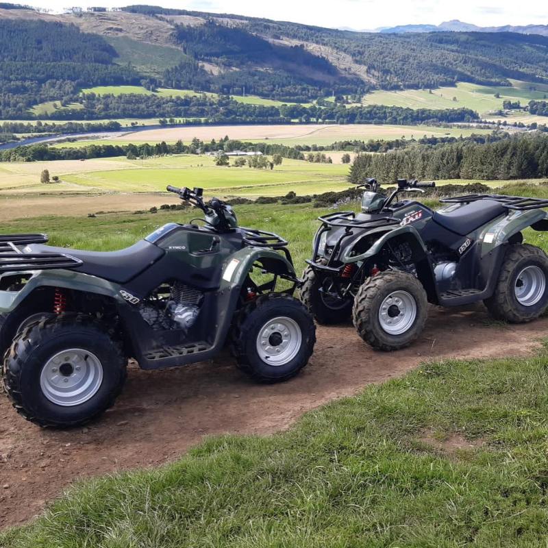 a motorcycle is parked on the side of a dirt field