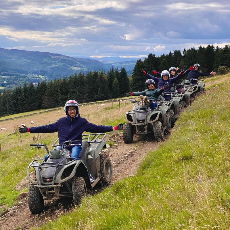 a man riding a motorcycle down a dirt road