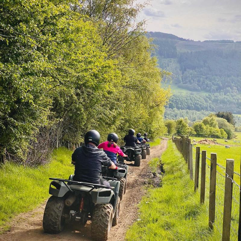 a person riding a motorcycle down a dirt road