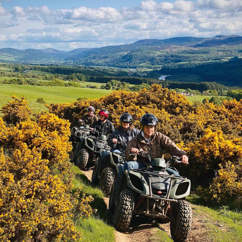 a man riding a motorcycle down a hill
